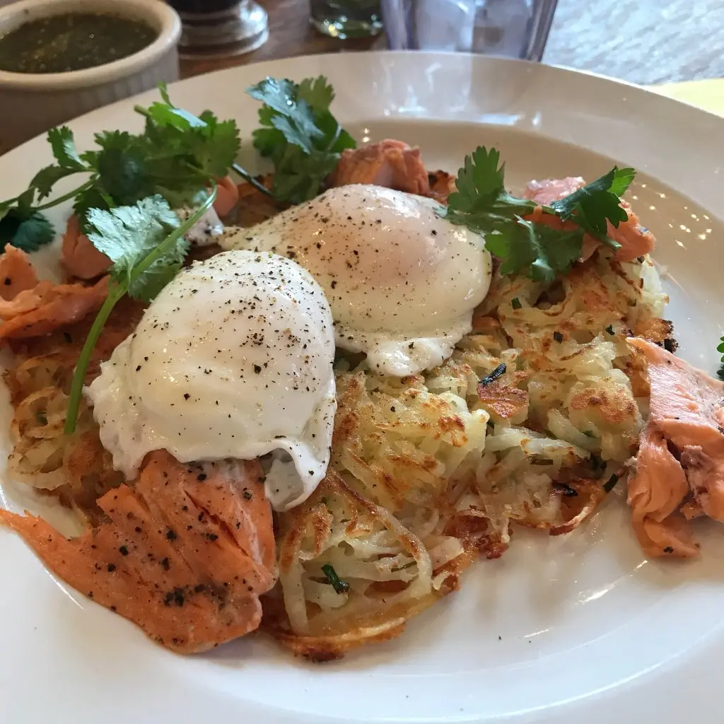 Cafe Pasqual’s signature dishes Huevos Motuleños, Chile Relleno, Smoked Trout Hash, Mole Enchiladas